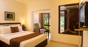 a hotel room with a bed and a window at Abad Copper Castle Resort in Munnar