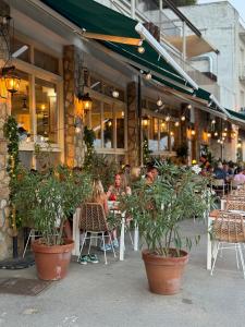 a group of people sitting outside of a restaurant at La Vela Estartit Rental in L'Estartit