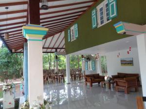 a lobby of a building with chairs and tables at Rimaka Village - Tourist Board Approved Hotel in Habarana