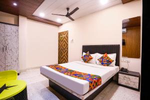a bedroom with a bed and a ceiling fan at FabHotel Nilsa in Pālghar