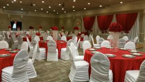 a banquet hall with red and white tables and chairs at Plaza Hotel & Casino in Las Vegas
