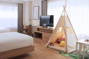 a bedroom with a bed with a tent in it at Courtyard by Marriott Bangkok in Bangkok