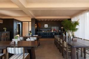 a dining room with wooden tables and chairs at Lijiang Chenxi View Hotel in Lijiang