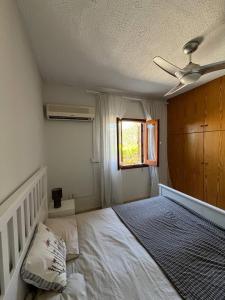 a bedroom with a bed and a ceiling fan at The Citrus Valley in Pissouri +14 photos