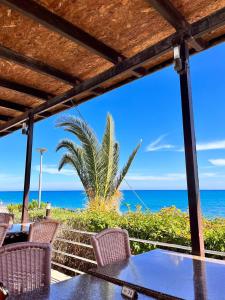 a table with chairs and a view of the ocean at The Citrus Valley in Pissouri