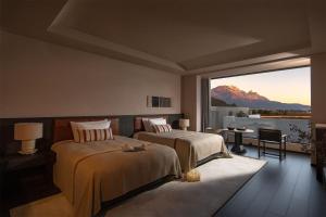 a bedroom with two beds and a large window at Lijiang Chenxi View Hotel in Lijiang +88 photos