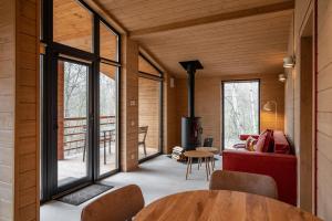 a room with a fireplace and a table and chairs at УЛІС Віняви in Derevach +46 photos