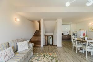 a living room with a couch and a table at Woodland Apartment in Silver Mountain Resort in Poiana Brasov