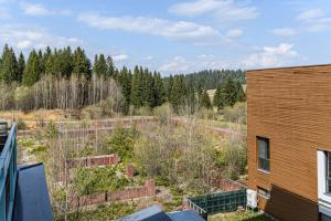 an aerial view of a garden next to a building at Woodland Apartment in Silver Mountain Resort in Poiana Brasov