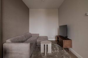 a living room with a couch and a table at Spacious family home in Schiedam