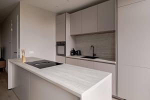 a kitchen with white cabinets and a counter top at Spacious family home in Schiedam