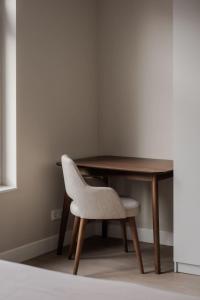 a wooden table with a chair and a wooden desk at Spacious family home in Schiedam +60 photos