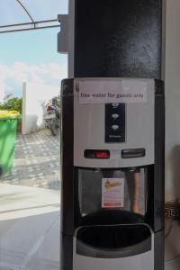 a free water dispenser at a gas station at Road Beach Cottages in Nusa Penida