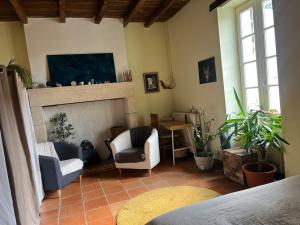 a living room with two chairs and a fireplace at Maison Périgourdine familiale in Saint-Jean-dʼEyraud