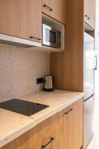 a kitchen with a counter top and a microwave at The Boc Hostels - City in Palma de Mallorca