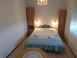 a small bedroom with a bed and a table at Gergócs Vendégház in Őriszentpéter