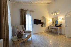 a living room with a couch and a table at Oliviera Private Island Hotel - Kalem Island in Kalem Adasi