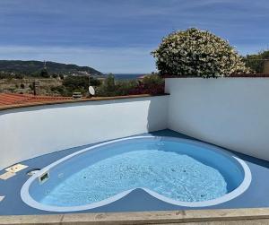 a hot tub sitting on the side of a building at Villa Thalea in Diano Marina