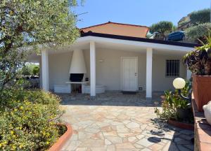 a white house with a patio in front of it at Villa Thalea in Diano Marina