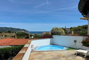 a hot tub on the patio of a house at Villa Thalea in Diano Marina
