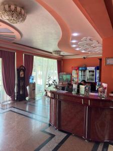 a bar in a hotel room with orange walls at Turkiston Hotel in Namangan