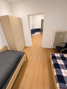 a bedroom with a bed and a room with a couch at Apartment Rahden in Rahden