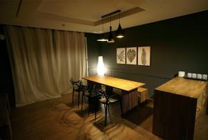 a room with a table and chairs and a bar at Statehouse pension Incheon in Incheon