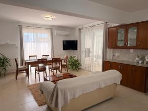a living room with a couch and a table at Villa Andy-350 m from the beach in Larnaca