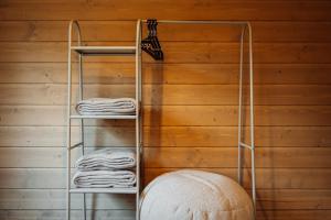 a towel rack against a wooden wall with towels at УЛІС Віняви in Derevach