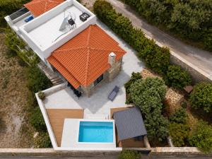 an overhead view of a house with an orange roof at Aurora Spinalonga Garden Villa with Jacuzzi Pool in Chavgas