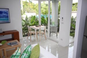 a living room with a white table and chairs at Samui Sunrise 41B in Choeng Mon Beach