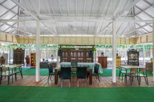 a dining area with tables and chairs in a tent at Urbanview Onengan Resort in Palang-Putih