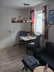 a living room with a couch and a table at Ferienwohnung Benzmann in Süderbrarup