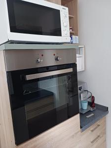 a microwave sitting on top of a oven at Ferienwohnung Benzmann in Süderbrarup