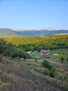 a view of a field with a house in the distance at Villa Home in Ganja