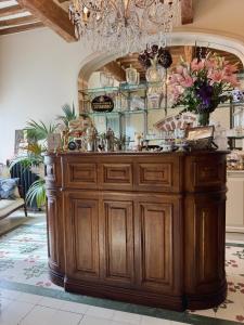a large wooden buffet in a room with a chandelier at Dimora Decò in Lugo