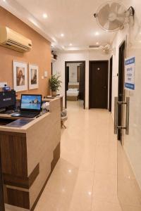 a lobby of a hospital with a desk with a laptop at Hotel Sunview in Kolkata
