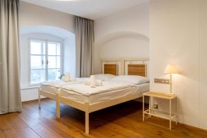 a bedroom with a bed and a window at Hotel Zámek Svijany in Svijany