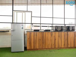 a kitchen with a refrigerator and a counter at Z Express Leela in Bangalore