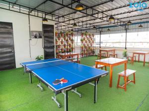 a ping pong table in a room with tables and chairs at Z Express Leela in Bangalore +12 photos