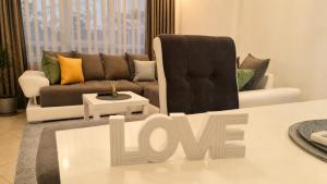 a living room with a couch and a chair at Luxury Apartment Paraćin - River View in Paraćin +5 photos