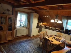 a kitchen and dining room with a table and chairs at Ferienwohnung Jauk in Gleinstätten