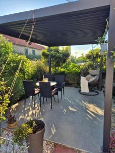 a patio with a table and chairs under a pergola at Rural Apartment Ante in Drniš +27 photos