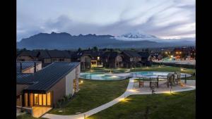 a view of a resort with a mountain in the background at Departamento Condominio Costa Pucon in Pucón