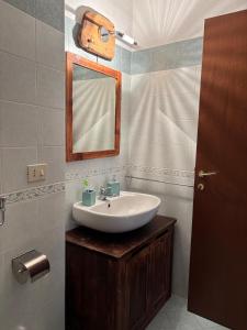 a bathroom with a sink and a mirror at Appartamento Grangia Rigat, Bousson, Cesana Torinese in Bousson