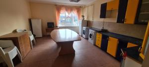 a small kitchen with a table and a window at Casa Regina Pacis in Vărvăreuca