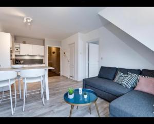 a living room with a couch and a table at Just like home De Haan aan Zee in De Haan