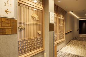a hallway with clocks on the walls of a building at Tokyo Asakusabashi Belmont Hotel in Tokyo