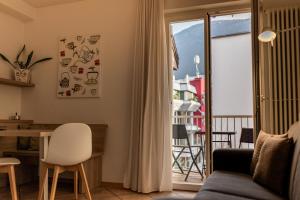 a living room with a couch and a table at Pixner Apartments in Bolzano