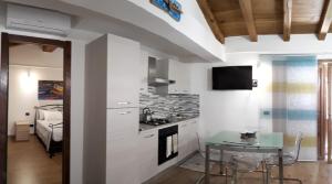 a kitchen with a small table and a kitchen with a stove at La Palma in Lerici